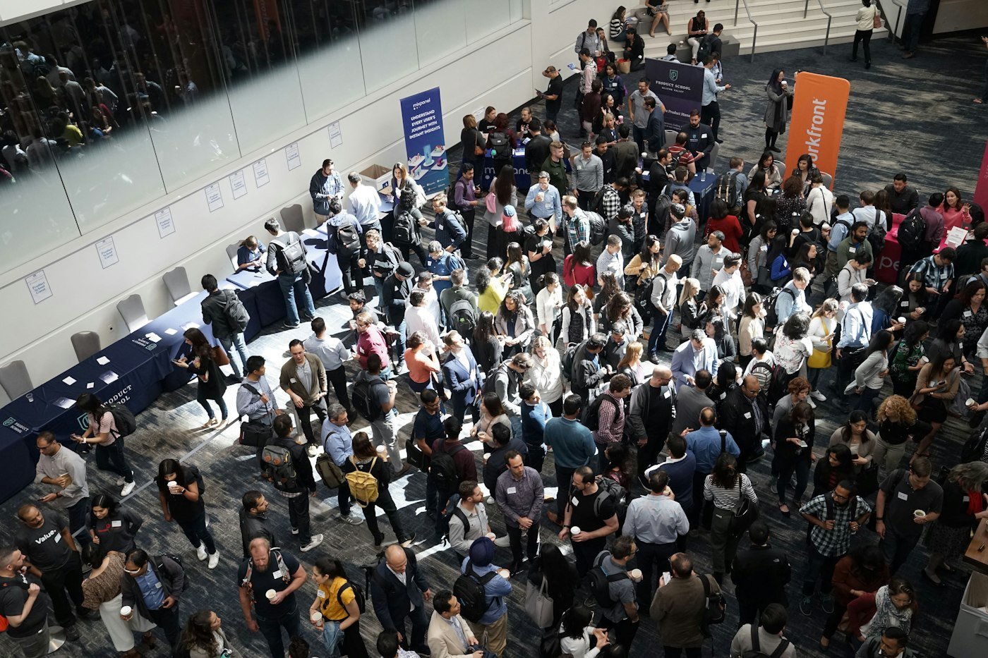 Busy conference networking area where NFC business cards are exchanged