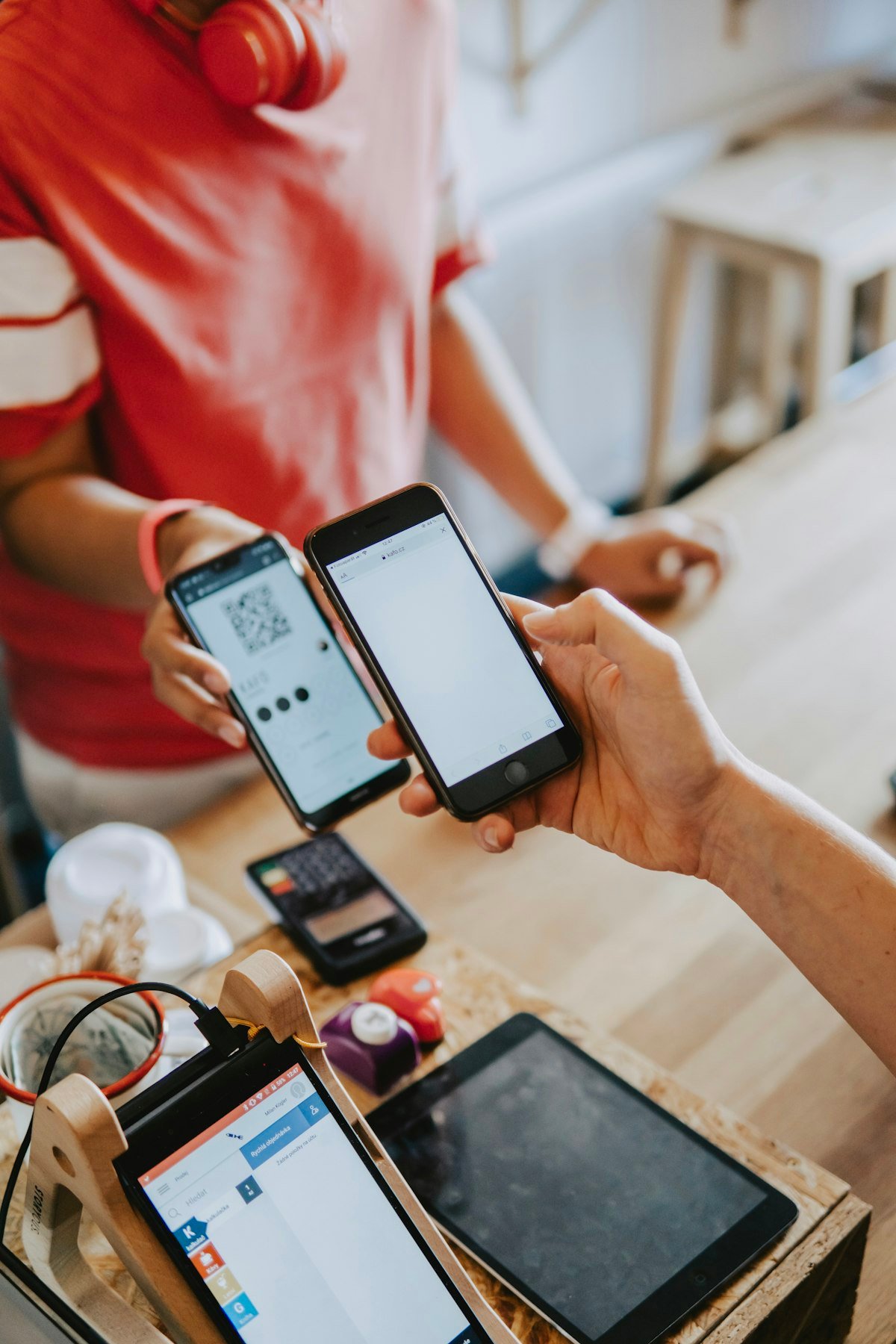 Two professionals exchanging contact details phone to phone with an NFC digital business card
