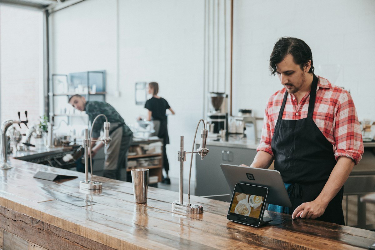 Cafe counter where a customer can tap an NFC review card to leave a Google review